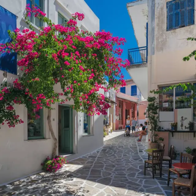 Chora Naxos with flowers and people walking its narrow alleys