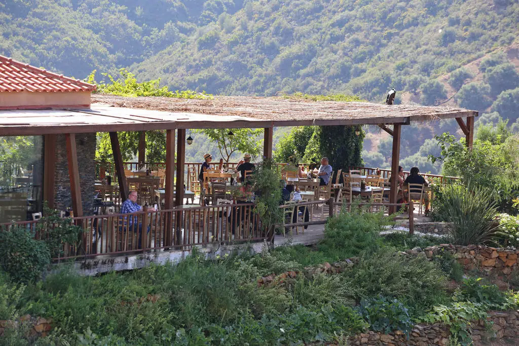 Botanical Park with some people sitting on the porch in Chania Crete Greece.