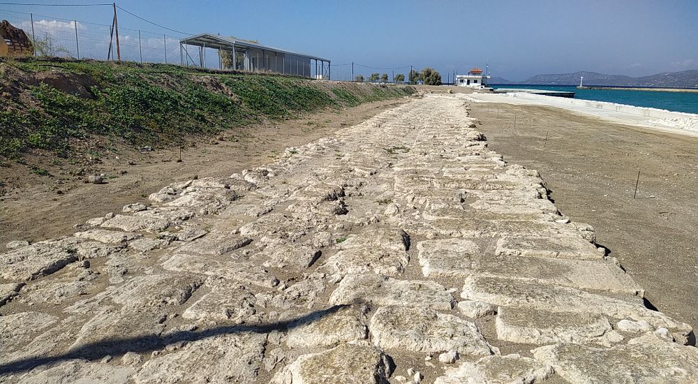 Remnants of the Diolkos pathway in Ancient Corinth, stretching towards the sea.