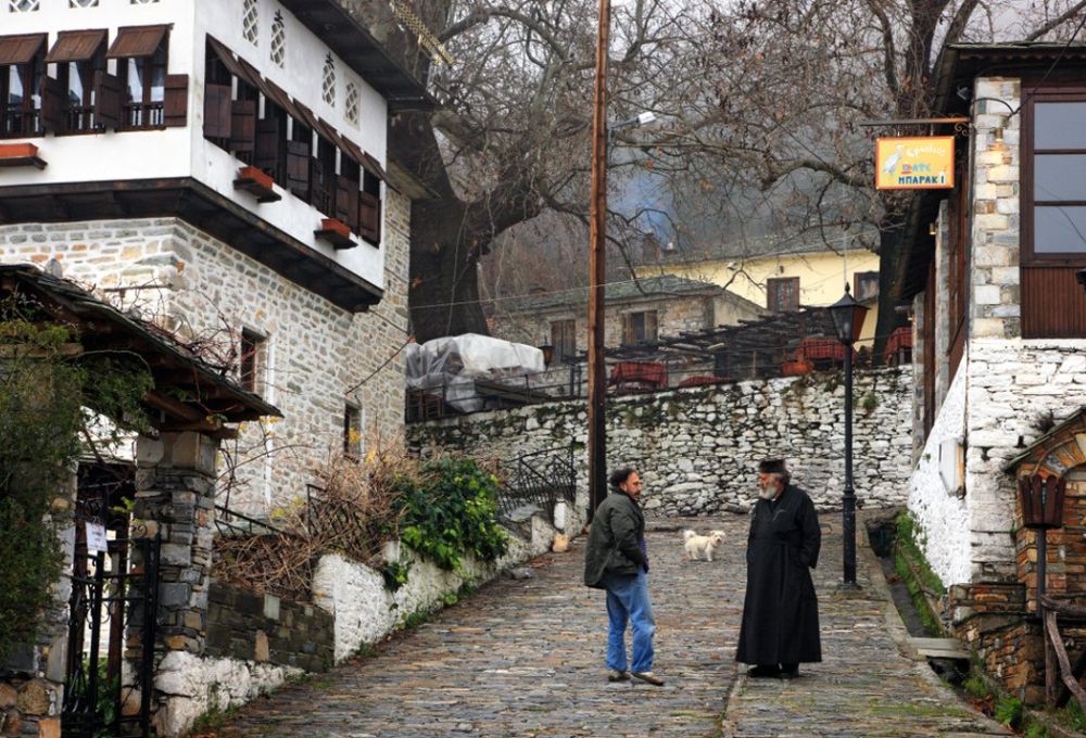 What best to do in Pelion Greece, Vyzitsa village 2 locals discussing in winter