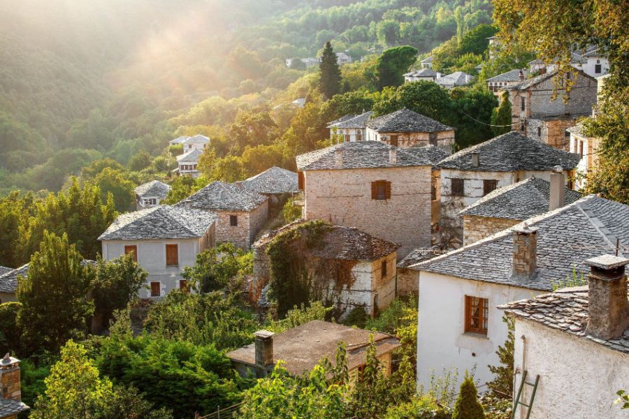 A stone built village surrounded by lush greenery on Pelion mountain in Greece. 