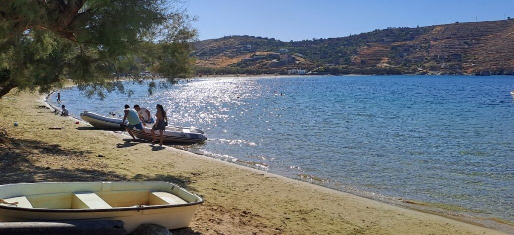 A sandy beach called Otzias with some people on Kea island.