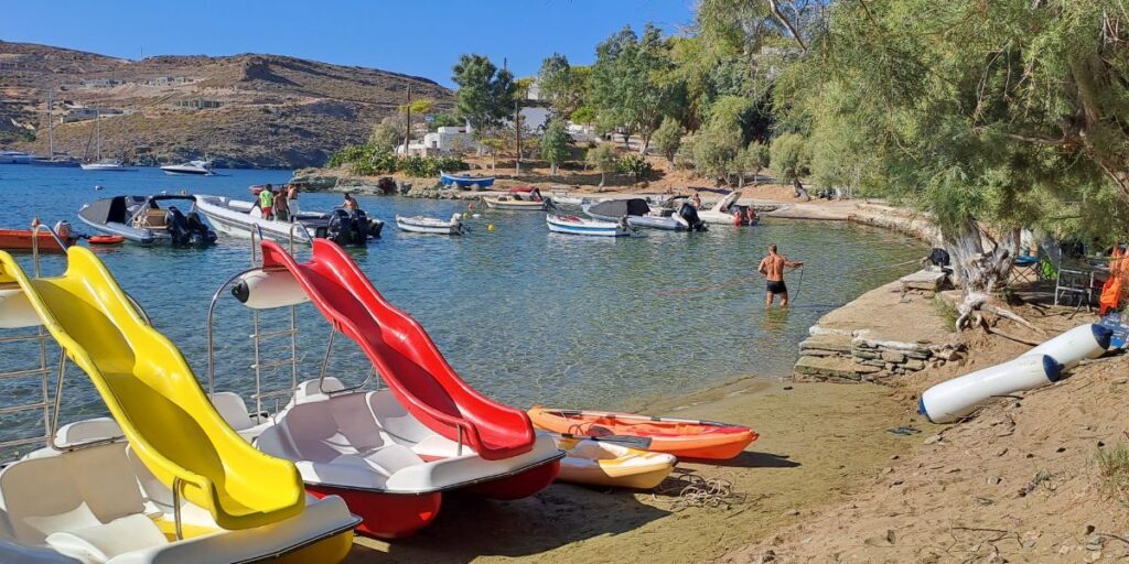Otzias sandy beach in Kea island with waterslides, boats and swimmers. 