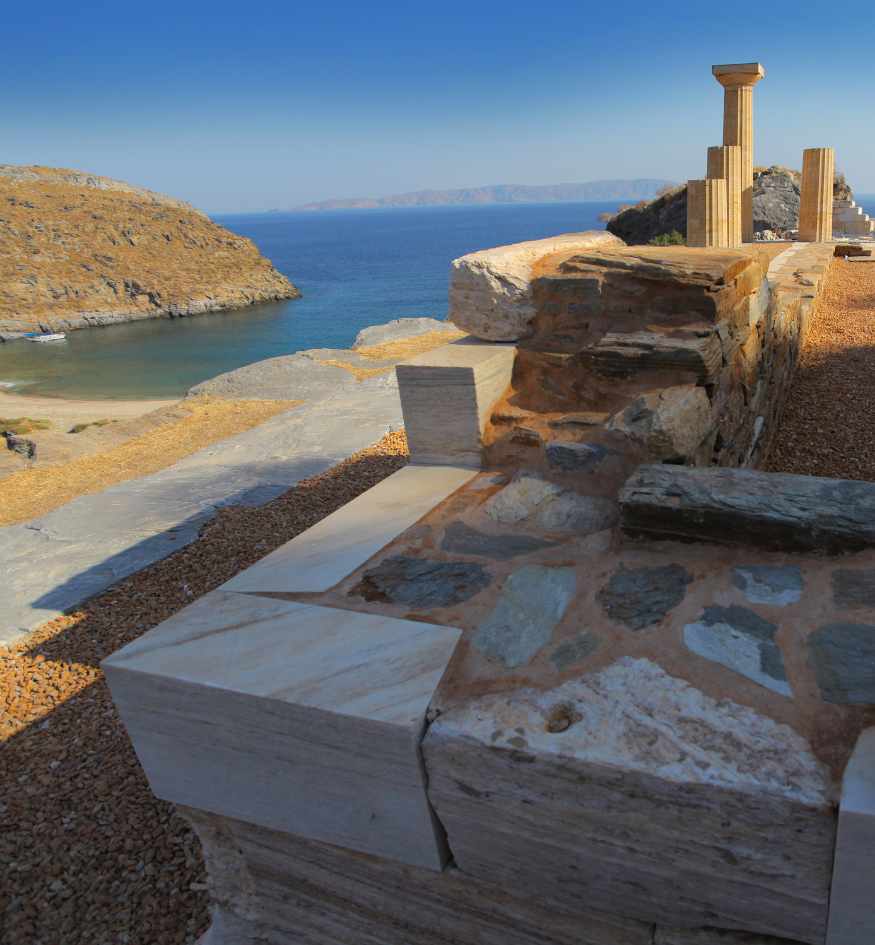 Ancient ruins of the Temple of Athena in Karthea, Kea island, Greece featuring marble columns overlooking the Aegean Sea and Poles Bay.