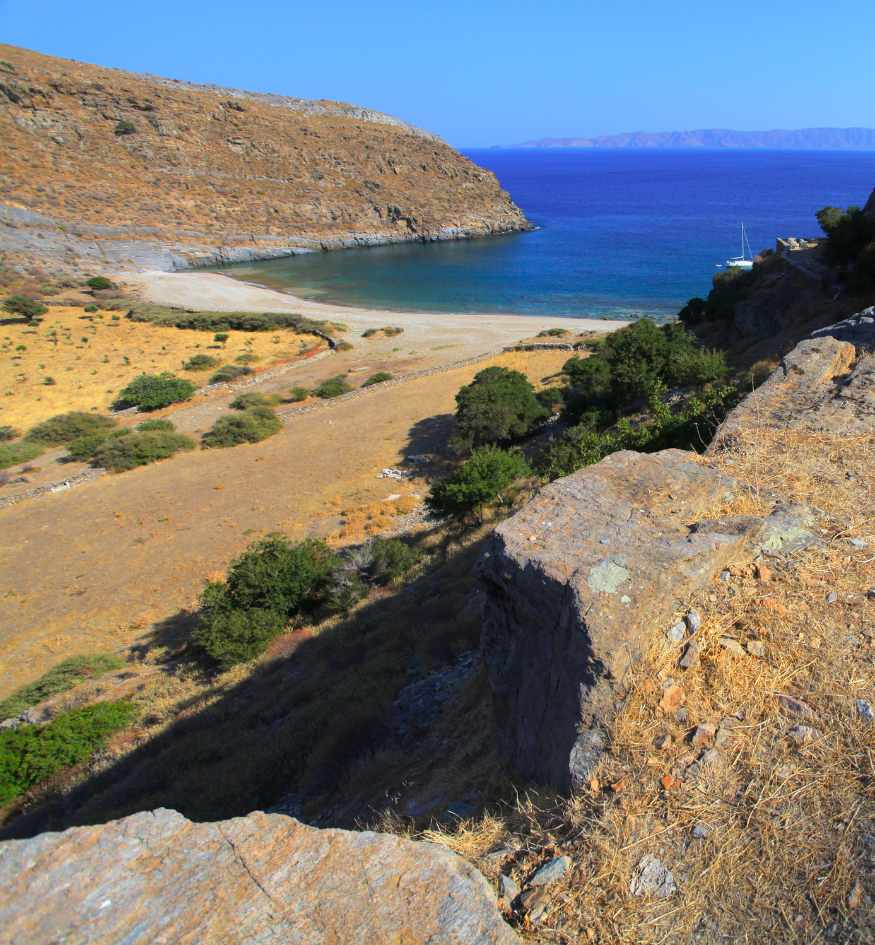 High-angle view of the secluded Poles Bay and Karthea beach on Kea Island, Greece accessible by ancient hiking trails and boat.