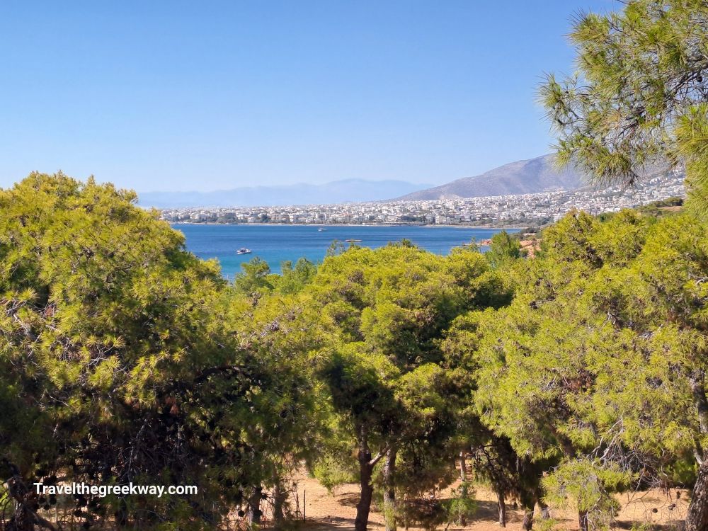 Scenic view of Athens Riviera from a wooded area overlooking the sea and the coastal city.