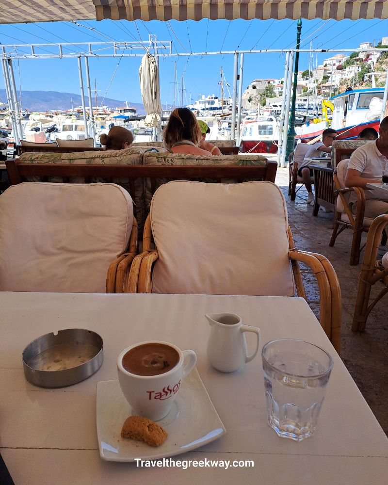 Greek coffee with a sea view at Hydra port café, with boats and scenic background – Hydra Island, Greece.