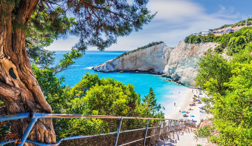 Things to do in Lefkada Greece: Stairs to get to Porto katsiki withpeople at the beach