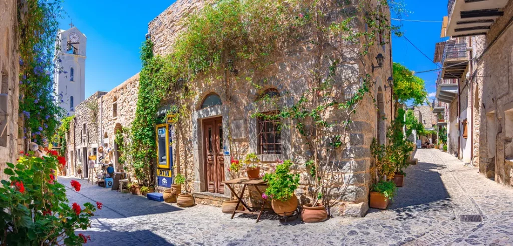 Chios Greece, Mesta village old stone buildings with plants and flowers