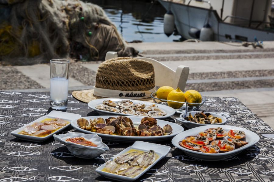 A table filled with seafood in the tavern of kakias in Salamina Island Greece.