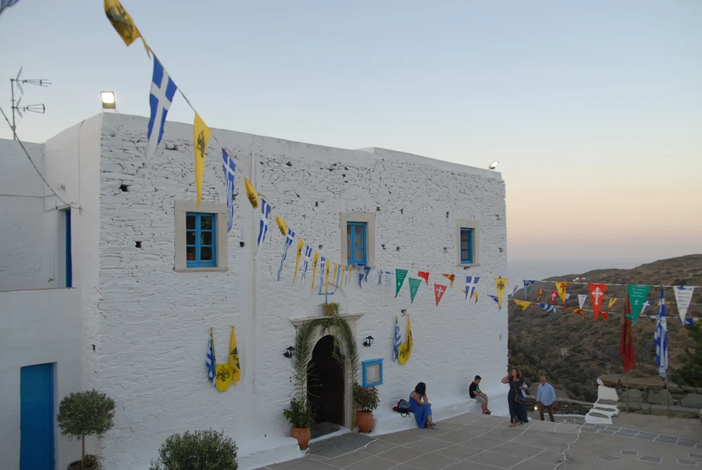 The Monastery of Panagia Vrysiani with flags in Sifnos Greece