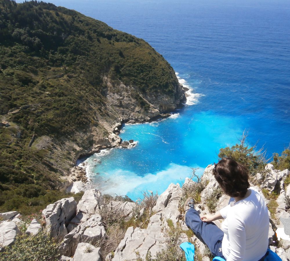 Best Things to do in Paxos Greece, Evgenia looking at the cliff!