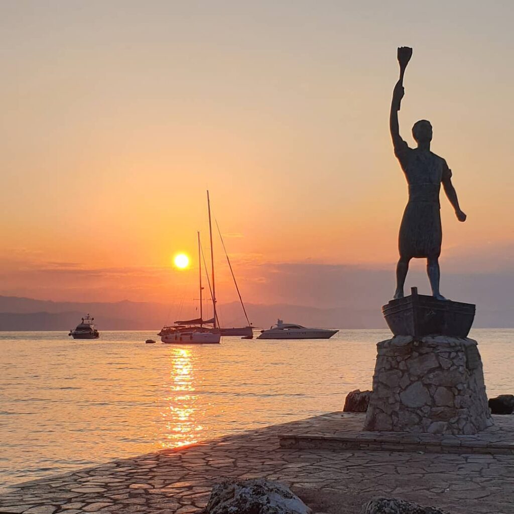 Best Things to do in Paxos Greece, Georgios Anemogiannis Statue in sunset