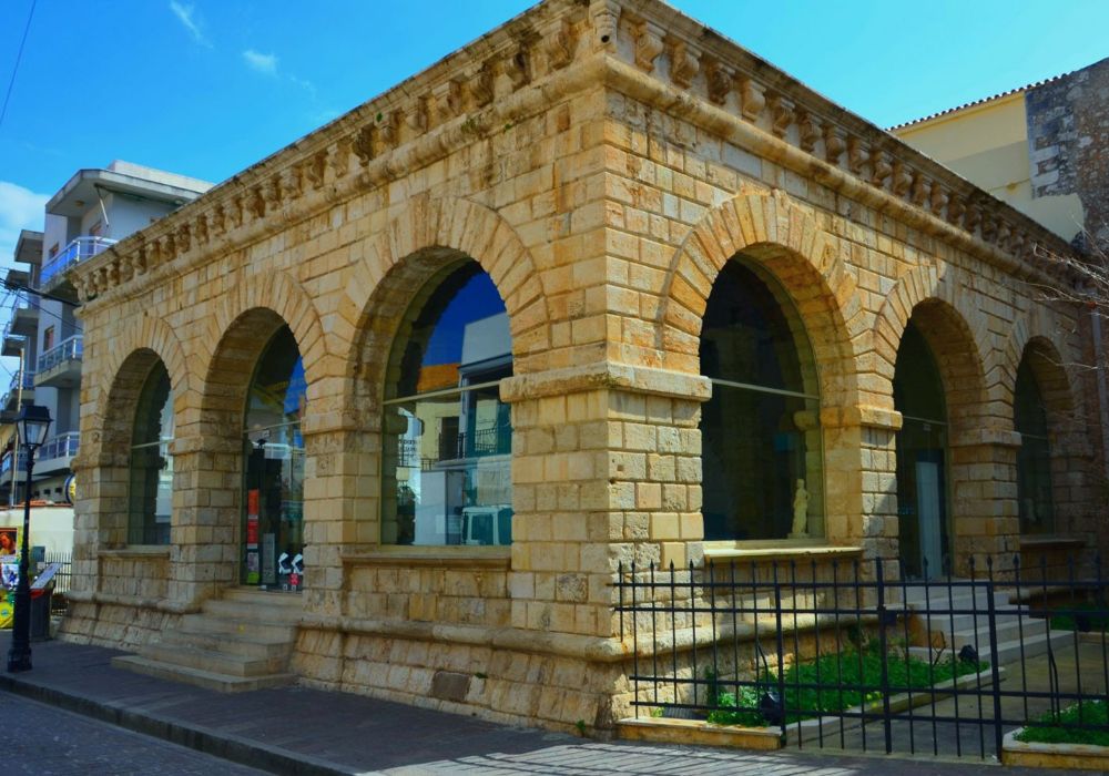 Historic Loggia of Rethymno, Crete, an elegant stone building with arched windows and a detailed cornice, showcasing Venetian architectural style.