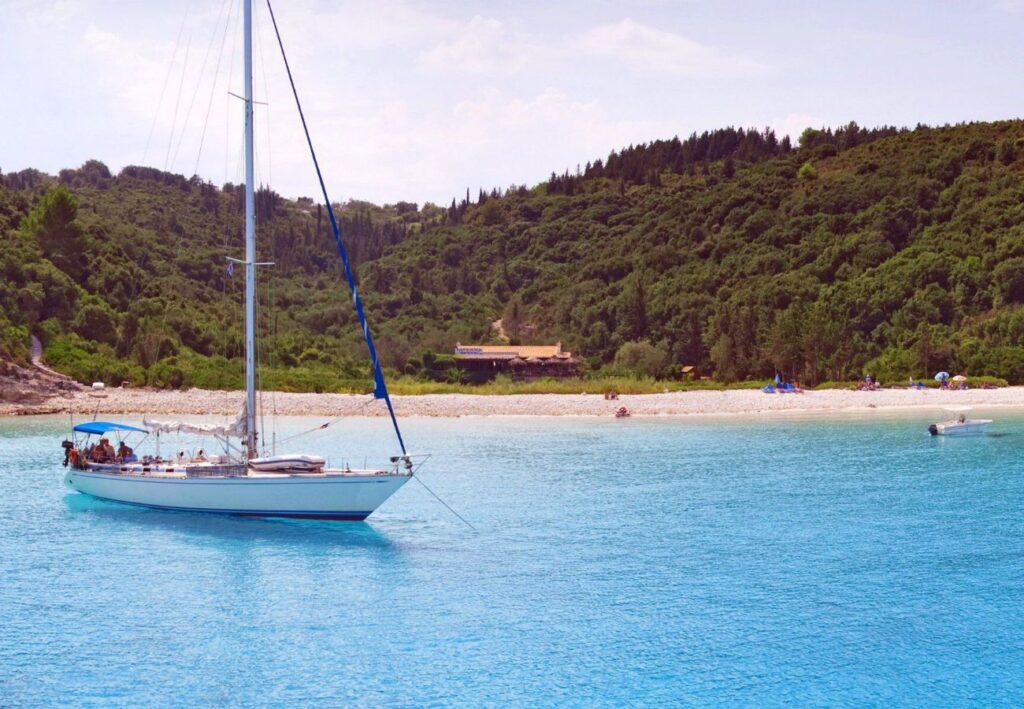 Best Things to do in Paxos Greece, Beach with a yacht