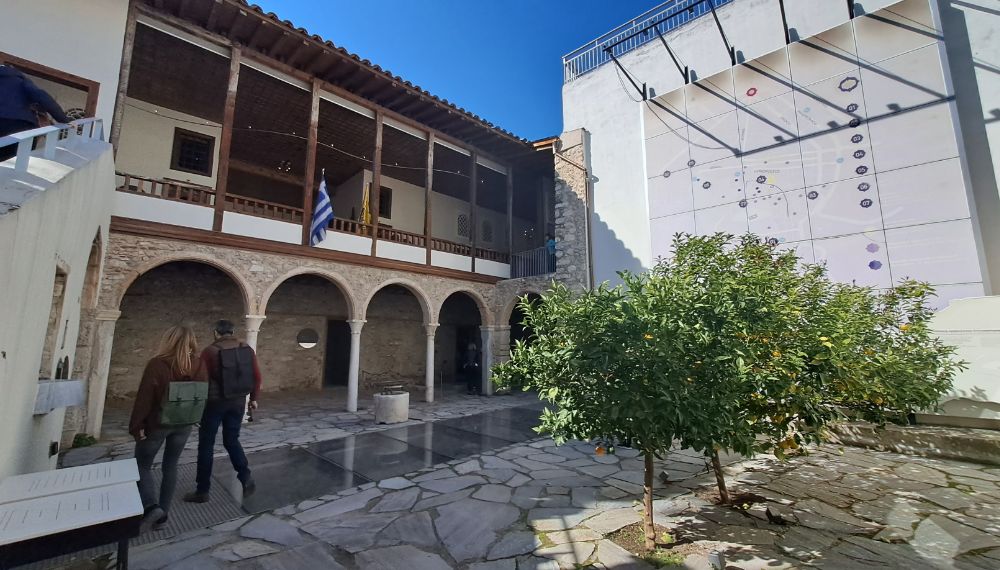Ottoman Built Benizelos House in Plaka with two trees and two people walking