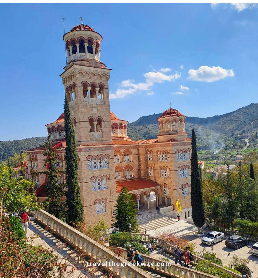 The grand architecture and stone bell tower of the famous Agios Nektarios Monastery on Aegina Island, Saronic Gulf, Greece.