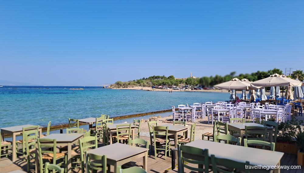 Seafront taverns with tables and chairs in Aegina. 