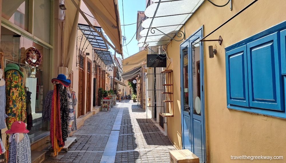 A cobblestone alley with shops in Aegina town. 