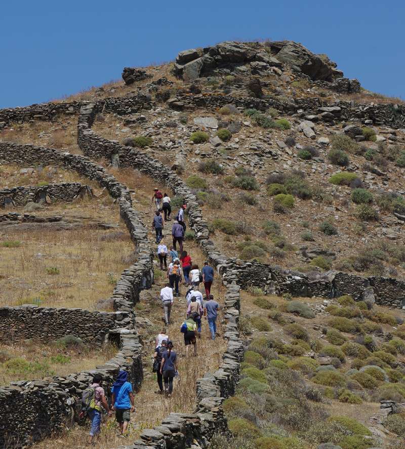 A group of people hike to Vryokastro in Kythnos Greece