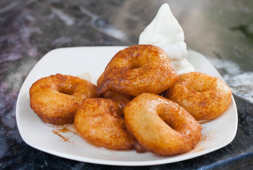 Greek style donuts with honey and cinnamon served on a plate