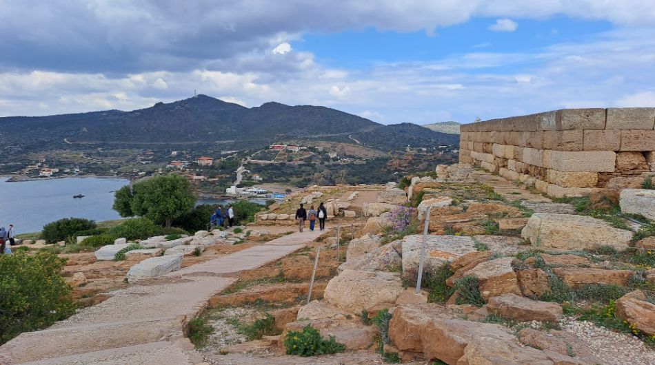 The Archeological Site of Poseidon Sanctuary in Cape Sounion with Two People Walking in Sounion Cape Athens Greece.