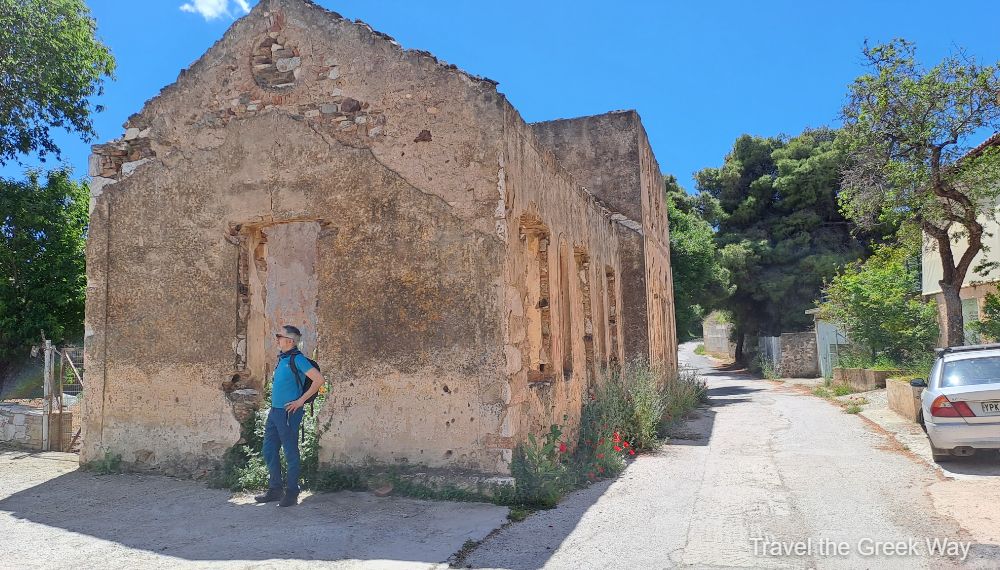 A man standing in front of Ruins of a mining building in Lavrio Port