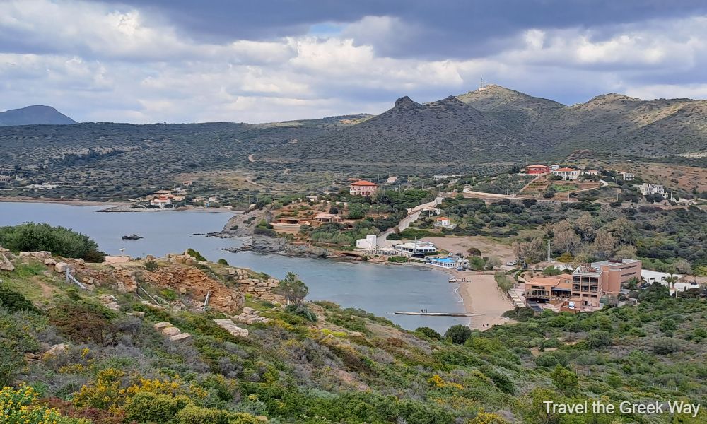 A Sandy Beach surrounded of Mountains and Some Houses  in Sounion Cape Athens Greece.