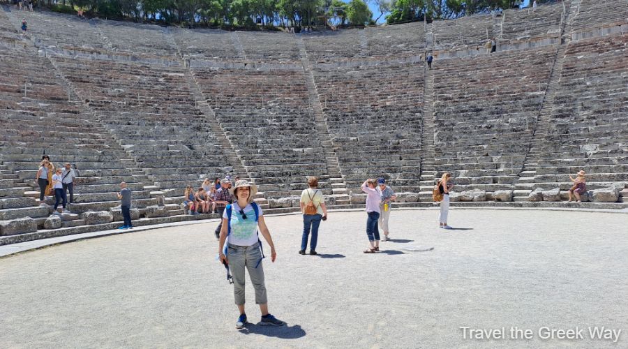 Evgenia in Ancient Theater of Epidaurus and some people in a sunny day in Theater of Epidaurus Peloponnese.