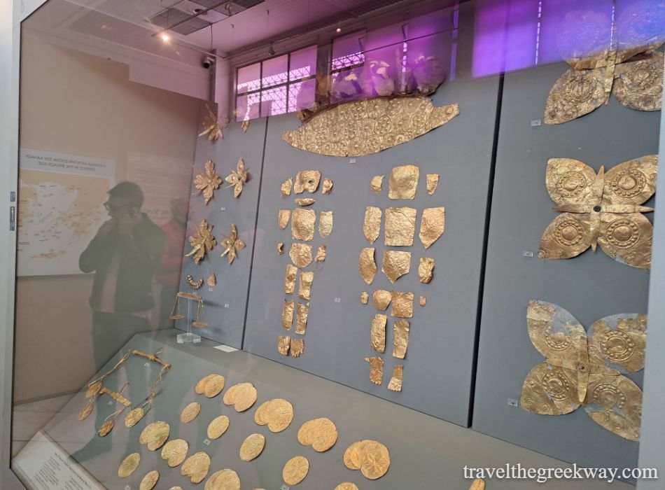 Additional golden grave artifacts from Mycenae, Greece, displayed in a museum, representing ancient burial customs.