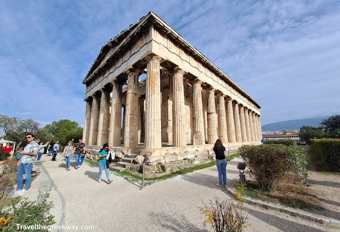 The Temple of Hepheastus in the Ancient Agora of Athens with tourists taking photos. 