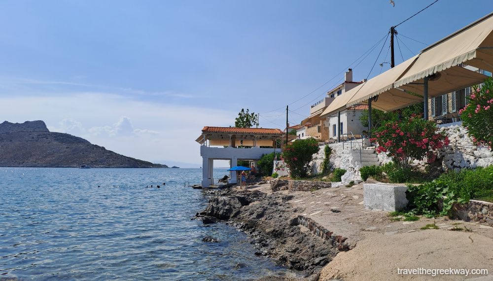 The rocky beach with a restaurant in Perdika village of Aegina. 