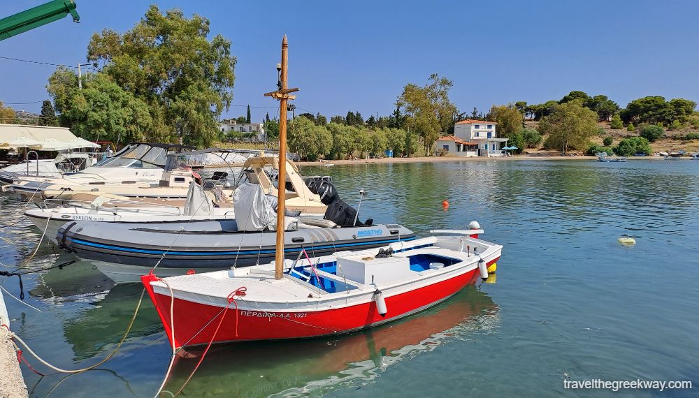 The port with fishing boats and a house in the beach in Aegina.