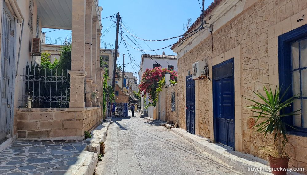 A characteristic street in Aegina street with old houses and flowers.