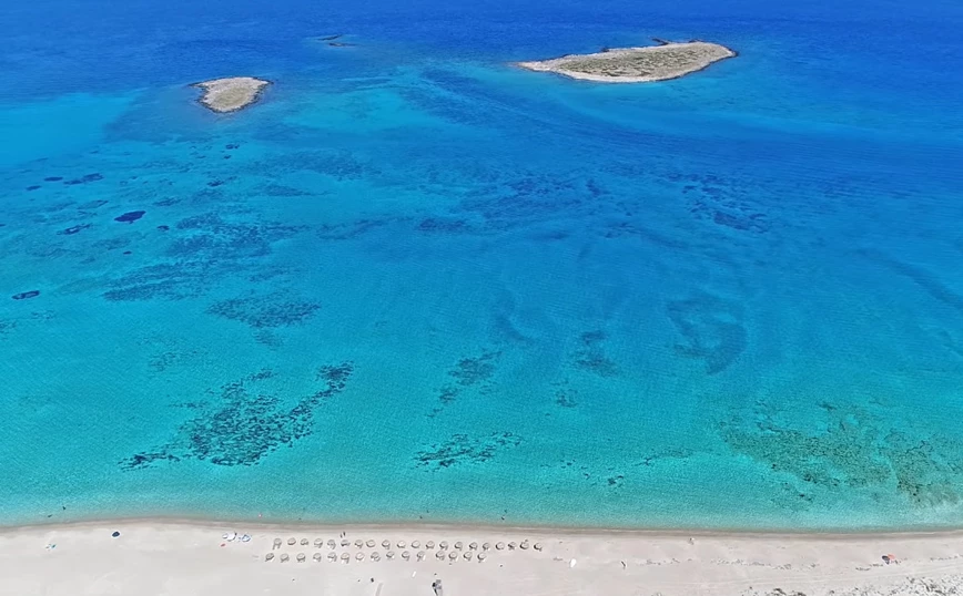 A drone view of a beautiful sandy beach with 2 islets of Panagia in Elafonisos