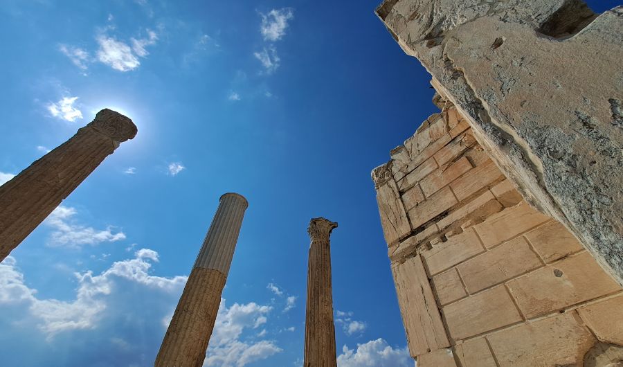 Ancient pillars of the Library of Hadrian soaring in the blue athenian sky. 