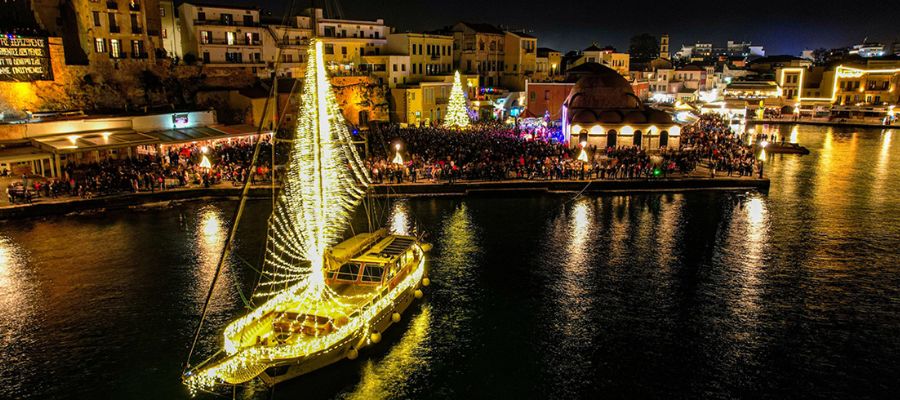 Crete in winter. Christmas decorations in the port of Chania with a boat decorated with lights. 