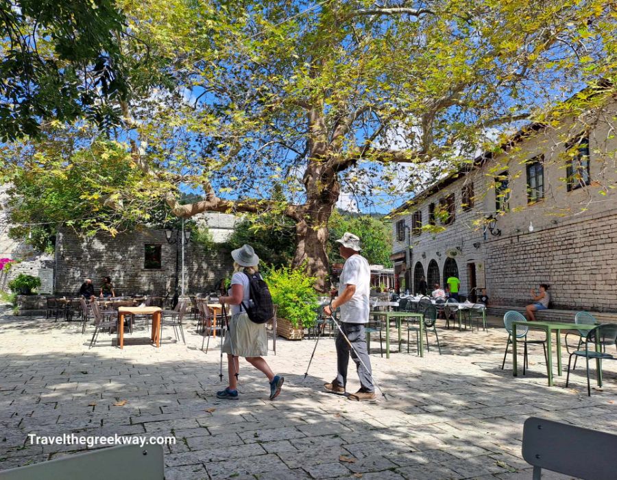 A couple walking in the main square of Monodendri Greece.