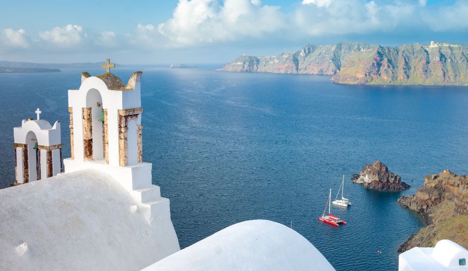 Sailing in Greece: 2 yahcts sailing along Santorini island.