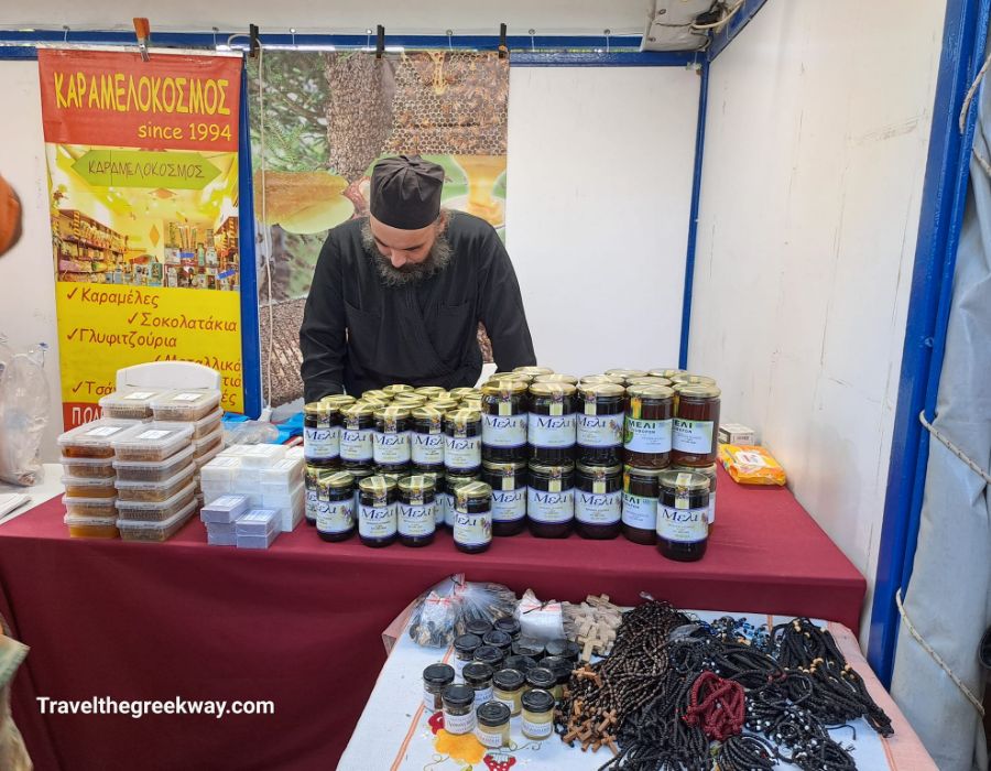 Greek Christmas Gifts: A priest selling Greek honey and other stuff at a kiosk. 
