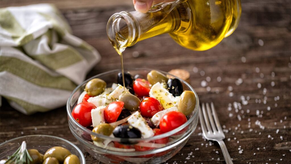 Greek Christmas Gifts: A plate of Greek Salad with a jar pouring olive oil. 