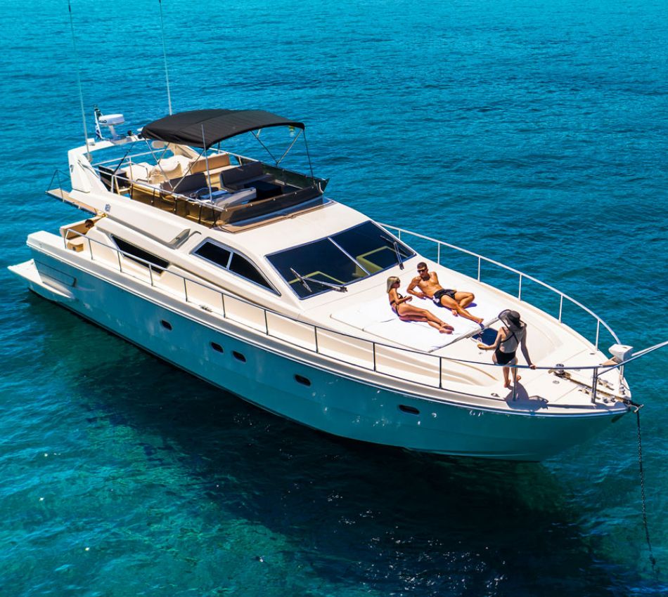 Sailing in Greece: A luxury yacht with 2 women and a man sunbathing. 