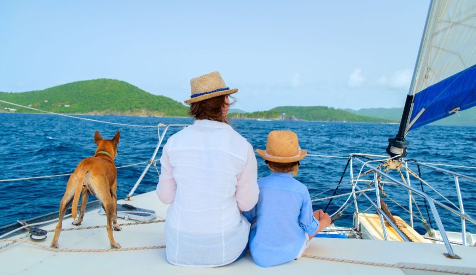 Sailing in Greece: A woman with a child and a dog on a yacht.