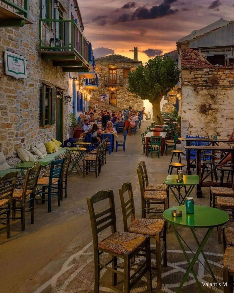 The traditinal stone built village of CHorio in ALonissos at dusk with people enjoying their dinners.