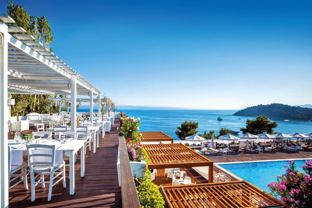 An overview of Skiathos Palace Hotel terrace and diner. 