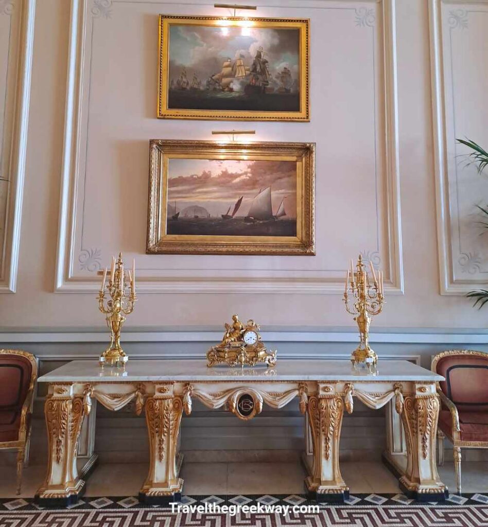 Antique gold console and maritime paintings inside the luxurious Hotel Grande Bretagne in Athens.