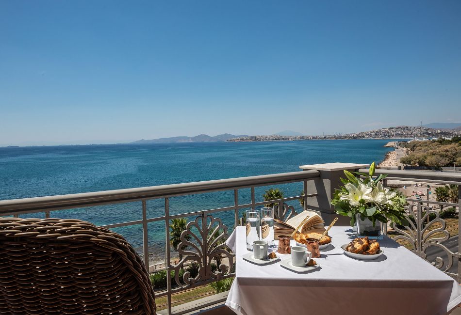 Breakfast setup on a balcony at Coral Hotel in Paleo Faliro, with a panoramic view of the sea.