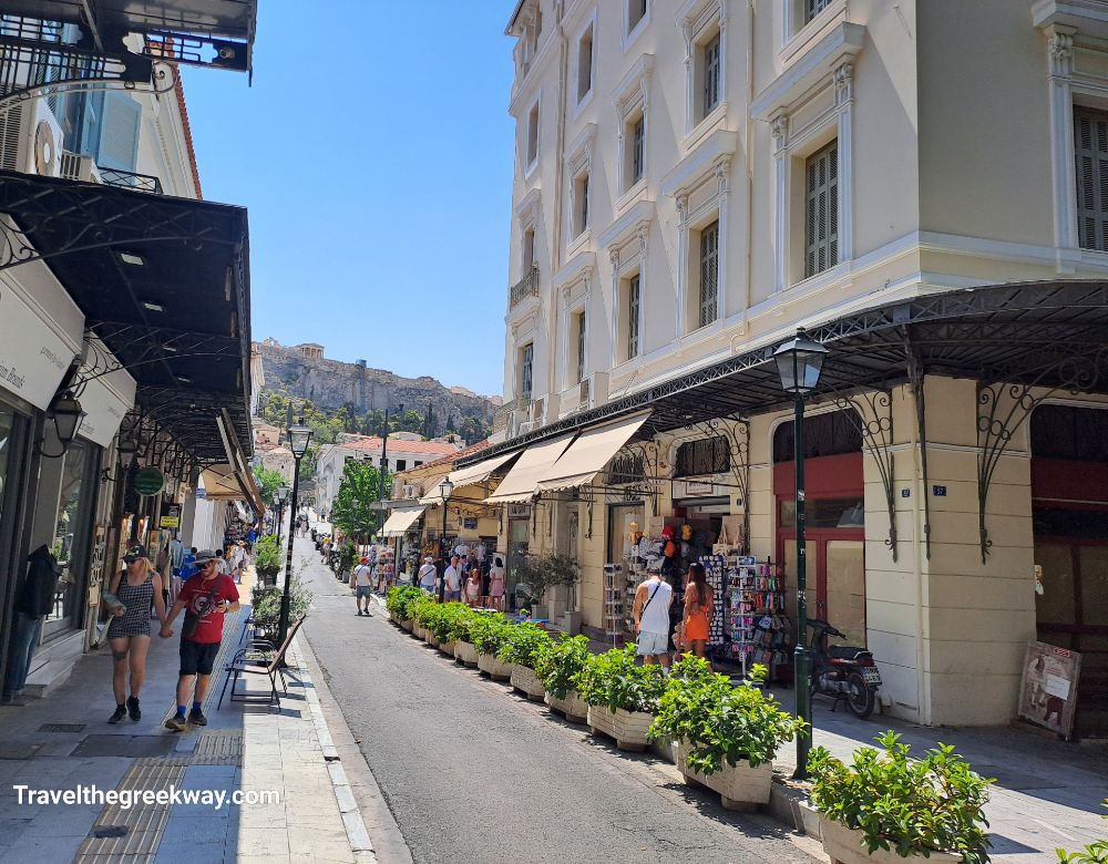 A view of the Acropolis from Monastiraki, Athens, with comfortable seating and a clear sky.