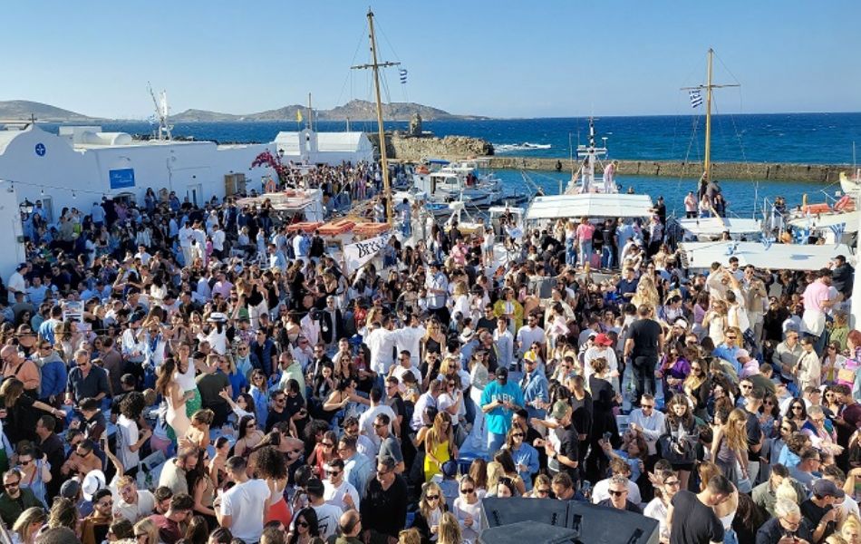 Crowded Easter celebration at the port of Naousa, Paros, with people gathered for festivities.