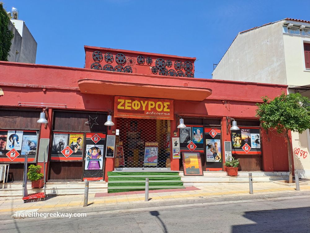 The vibrant exterior of Zefyros Art Cinema in Athens, featuring movie posters and classic decor.